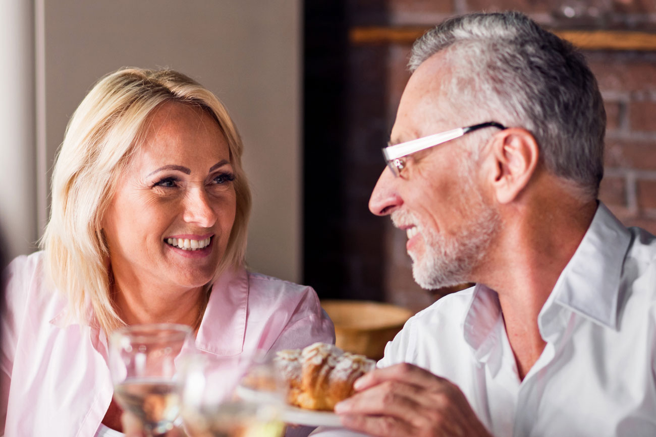 Two nice people chatting at dinner table