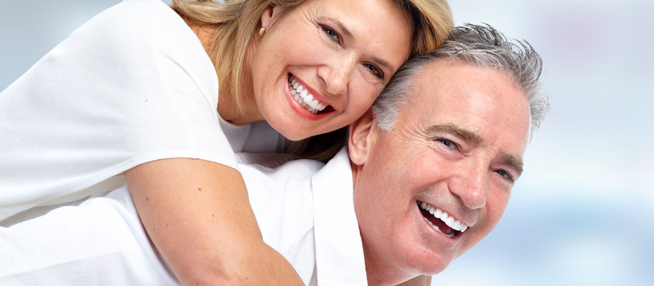 Happy senior couple smiling with bright white teeth